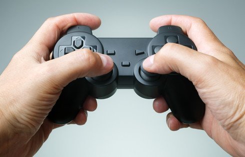 Video game console controller in gamer hands