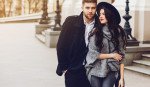 Two lovers posing against theater background